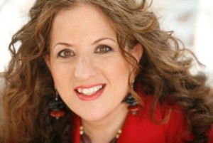 A woman with long curly hair wearing red.