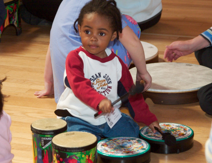 A little boy that is sitting on the floor