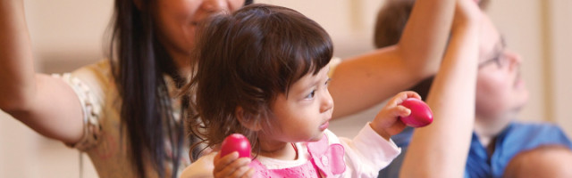 A woman and child playing wii with nintendo controllers.