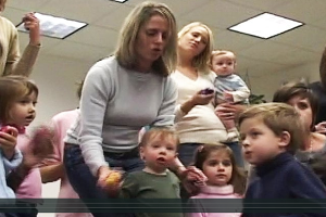 A group of women and children in an office building.